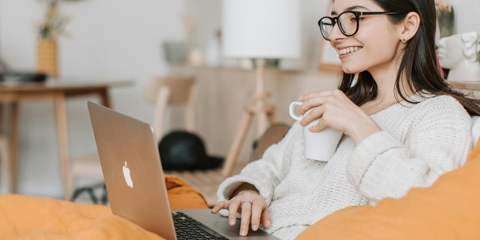 Girl with laptop working on the sofa